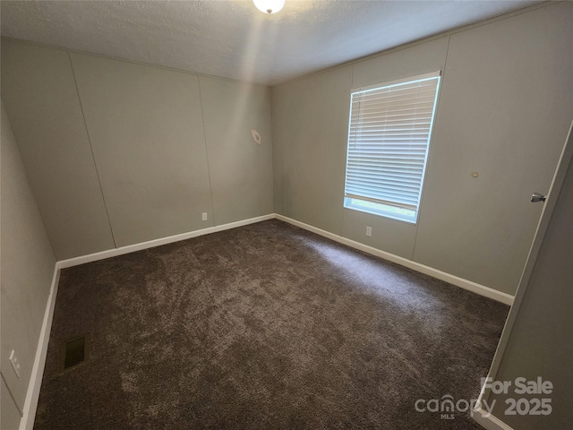 544 Bentley Rd, Shelby, NC 28152 - unfurnished room featuring baseboards, dark carpet, and a textured ceiling
