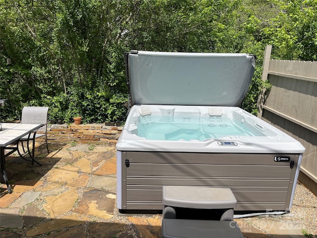 view of patio / terrace with a hot tub