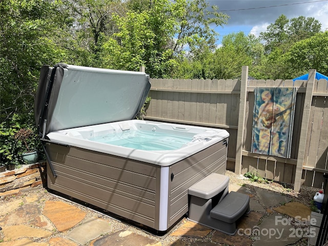 exterior space with fence and a hot tub