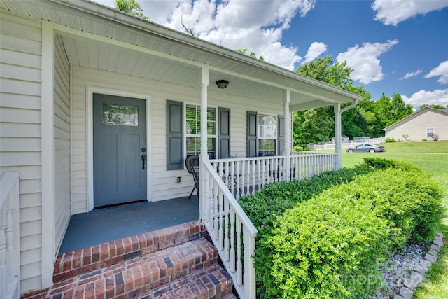 entrance to property featuring a porch