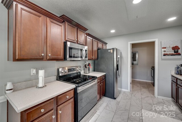 kitchen featuring stainless steel appliances, baseboards, light countertops, marble finish floor, and recessed lighting