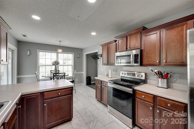 kitchen with visible vents, light countertops, marble finish floor, and appliances with stainless steel finishes