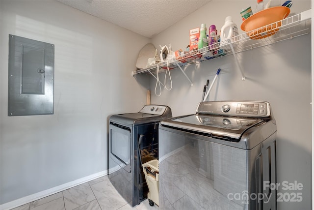 laundry area featuring electric panel, marble finish floor, independent washer and dryer, laundry area, and baseboards