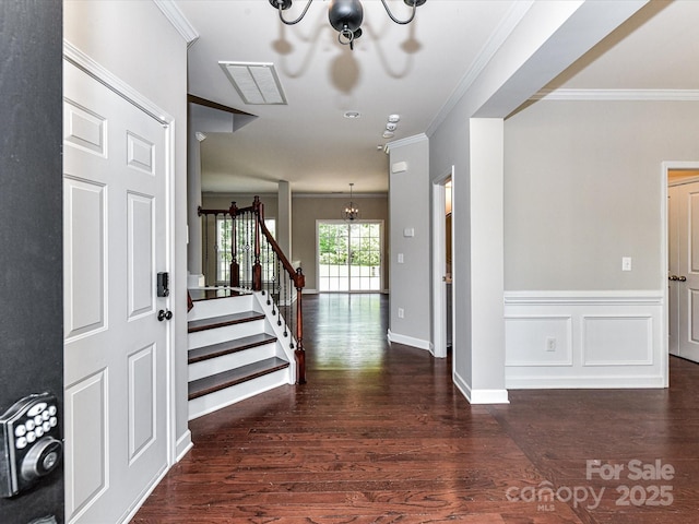 2369 Baxter Pl SE, Concord, NC 28025 - foyer featuring crown molding, stairway, wood finished floors, and a chandelier