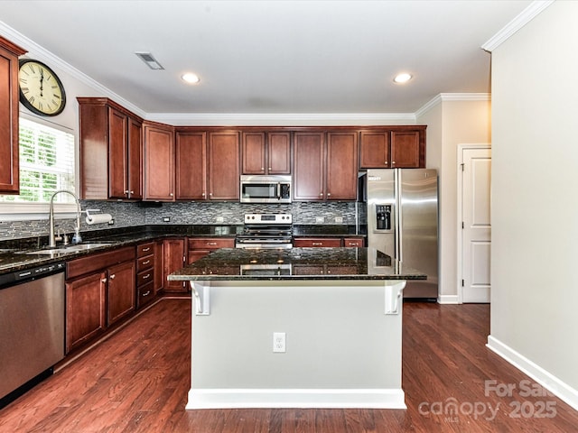 2369 Baxter Pl SE, Concord, NC 28025 - kitchen with appliances with stainless steel finishes, visible vents, ornamental molding, and a sink