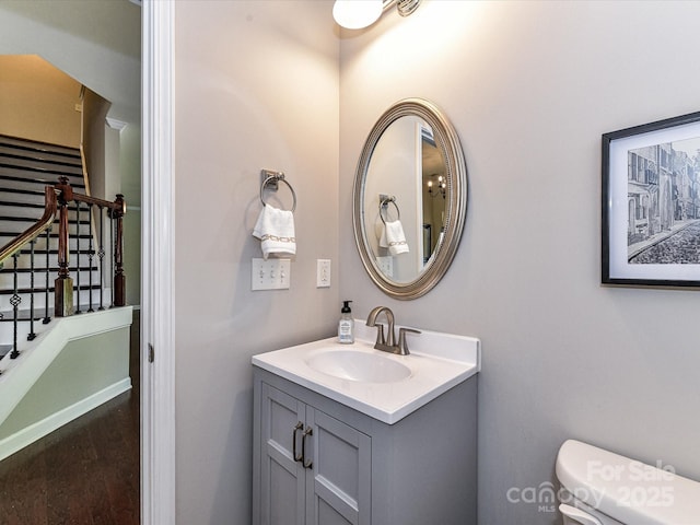2369 Baxter Pl SE, Concord, NC 28025 - bathroom with baseboards, wood finished floors, toilet, and vanity
