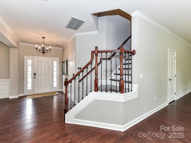 2369 Baxter Pl SE, Concord, NC 28025 - entryway featuring ornamental molding, wood finished floors, visible vents, and a chandelier