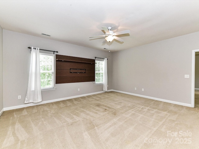 2369 Baxter Pl SE, Concord, NC 28025 - spare room featuring baseboards, visible vents, a ceiling fan, and light colored carpet