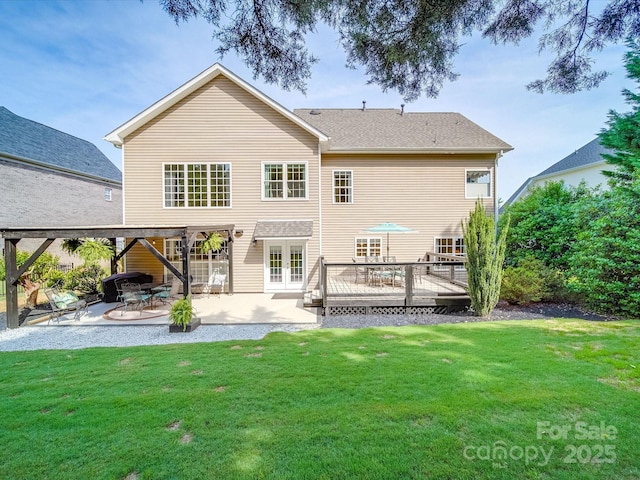 back of house with a lawn, a wooden deck, a patio area, and french doors