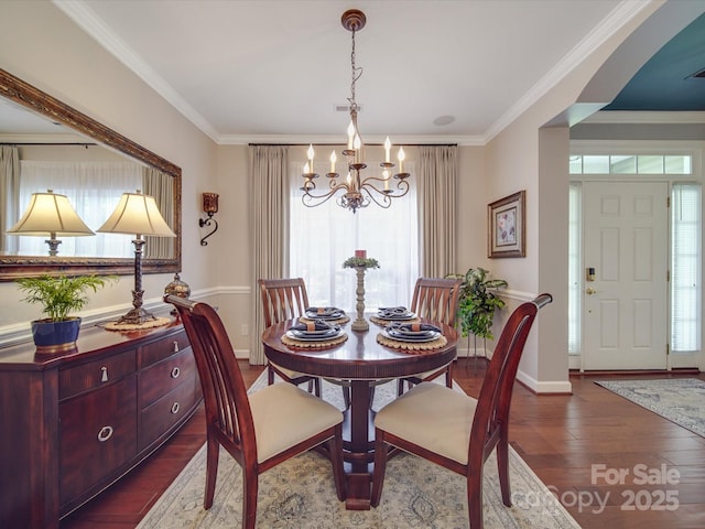 dining space featuring wood finished floors, a chandelier, and a healthy amount of sunlight