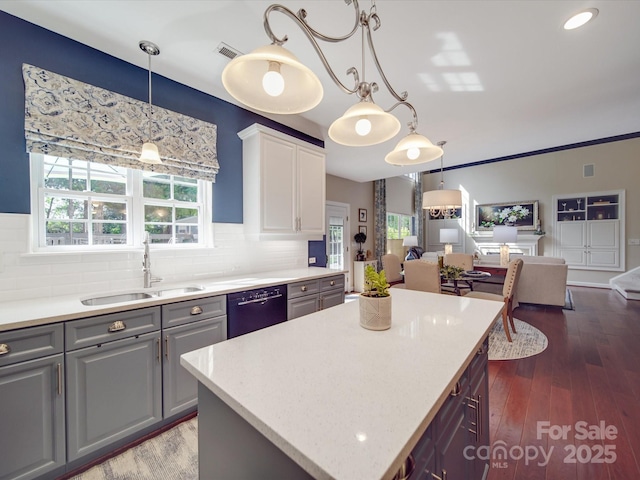 kitchen featuring a sink, open floor plan, decorative backsplash, gray cabinetry, and dishwashing machine