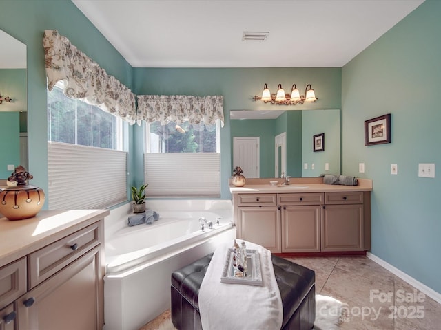 full bathroom with a garden tub, tile patterned floors, visible vents, and vanity