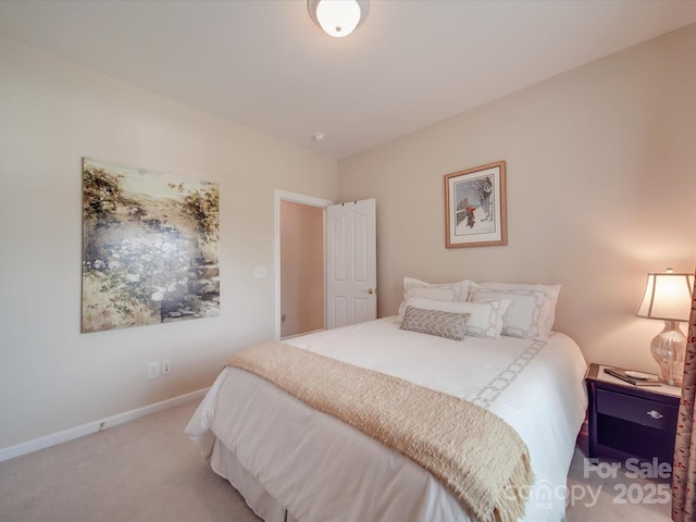bedroom featuring baseboards and carpet