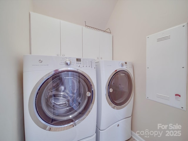 washroom with washer and dryer and cabinet space
