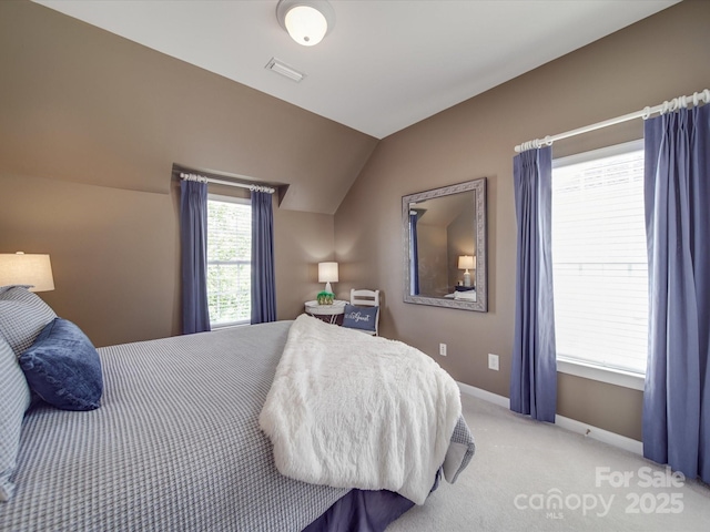 carpeted bedroom with baseboards, visible vents, and lofted ceiling