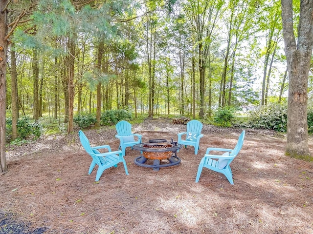view of yard with a fire pit