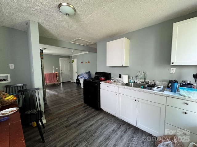 336 Hamilton Dr NE, Concord, NC 28025 - kitchen featuring a sink, a textured ceiling, dark wood finished floors, black electric range, and white cabinetry