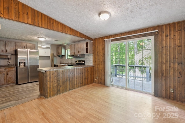 351 Fletcher Rd, Union Grove, NC 28689 - kitchen with a peninsula, a textured ceiling, appliances with stainless steel finishes, and wooden walls