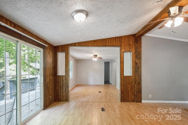 351 Fletcher Rd, Union Grove, NC 28689 - unfurnished room with wooden walls, a ceiling fan, lofted ceiling, and light wood-style floors
