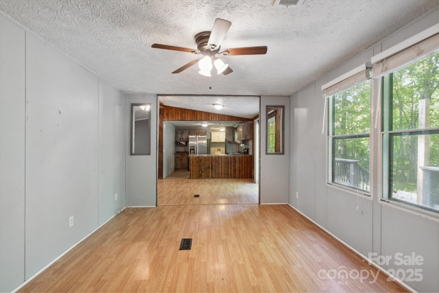 351 Fletcher Rd, Union Grove, NC 28689 - unfurnished living room featuring visible vents, a ceiling fan, a textured ceiling, and wood finished floors