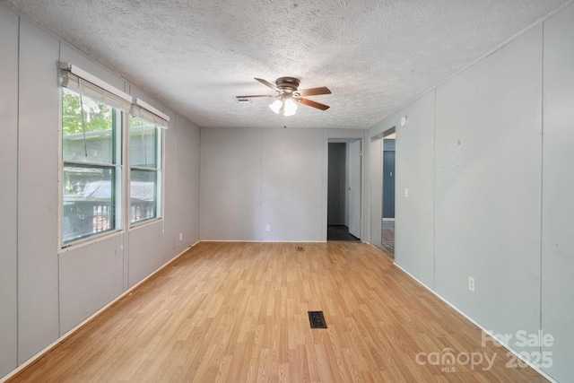 351 Fletcher Rd, Union Grove, NC 28689 - empty room featuring a textured ceiling, ceiling fan, and light wood-style floors