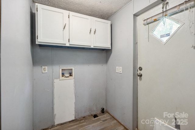 351 Fletcher Rd, Union Grove, NC 28689 - laundry room featuring cabinet space, a textured ceiling, wood finished floors, and hookup for a washing machine