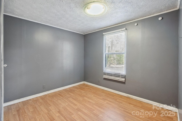 351 Fletcher Rd, Union Grove, NC 28689 - empty room featuring crown molding, baseboards, a textured ceiling, and wood finished floors