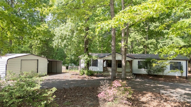 351 Fletcher Rd, Union Grove, NC 28689 - view of front facade with a carport, an outdoor structure, driveway, and covered porch