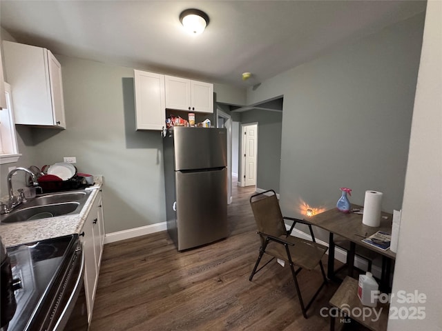 81 Academy Ave NW, Concord, NC 28025 - kitchen featuring freestanding refrigerator, range with electric stovetop, a sink, dark wood-style flooring, and white cabinets