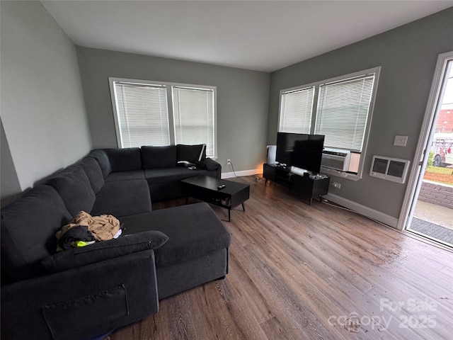 81 Academy Ave NW, Concord, NC 28025 - living room with wood finished floors, baseboards, and cooling unit