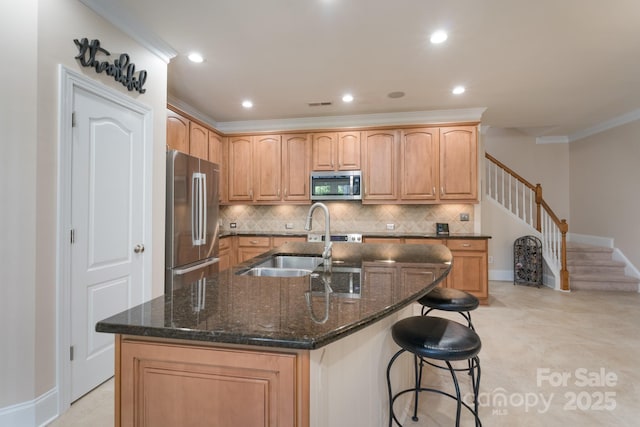11008 Round Rock Rd, Charlotte, NC 28277 - kitchen with a sink, a kitchen island with sink, stainless steel appliances, decorative backsplash, and ornamental molding