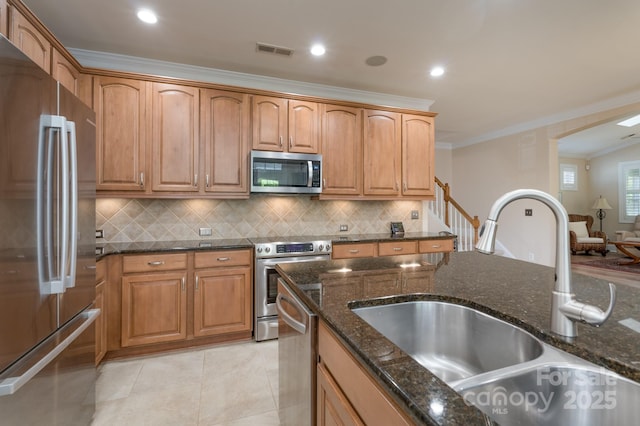 11008 Round Rock Rd, Charlotte, NC 28277 - kitchen featuring visible vents, crown molding, a sink, dark stone counters, and stainless steel appliances