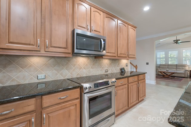 11008 Round Rock Rd, Charlotte, NC 28277 - kitchen featuring crown molding, decorative backsplash, ceiling fan, dark stone counters, and appliances with stainless steel finishes