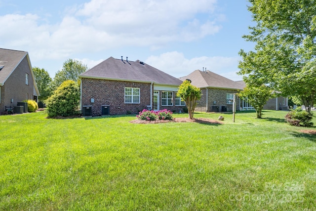 11008 Round Rock Rd, Charlotte, NC 28277 - rear view of property with a lawn, cooling unit, and brick siding