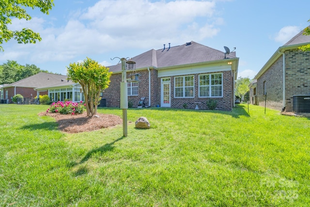 11008 Round Rock Rd, Charlotte, NC 28277 - rear view of property with a yard, central AC, and brick siding