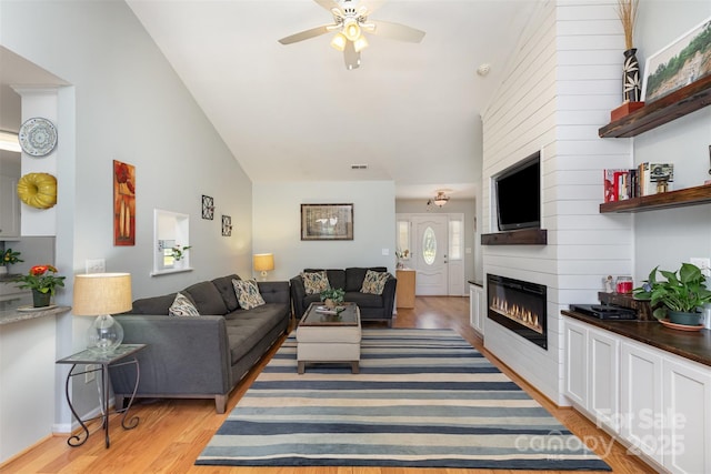 206 Summey Barker Dr, Dallas, NC 28034 - living area with light wood-style flooring, a fireplace, visible vents, a ceiling fan, and high vaulted ceiling
