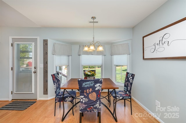 206 Summey Barker Dr, Dallas, NC 28034 - dining space featuring light wood finished floors, an inviting chandelier, a wealth of natural light, and baseboards