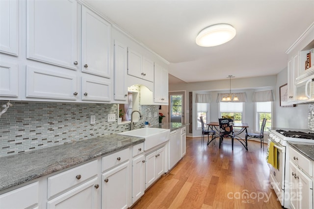 206 Summey Barker Dr, Dallas, NC 28034 - kitchen with white appliances, decorative backsplash, light wood finished floors, a sink, and white cabinetry