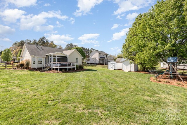 206 Summey Barker Dr, Dallas, NC 28034 - view of yard with an outdoor structure, a playground, a shed, fence, and a sunroom