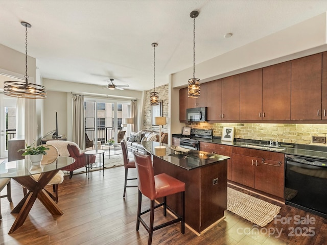 kitchen with black appliances, dark countertops, dark wood-style floors, and decorative backsplash