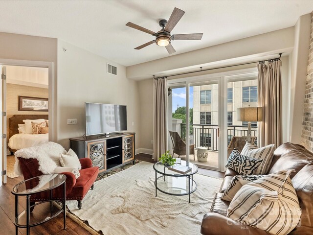 living area with wood finished floors, ceiling fan, and baseboards