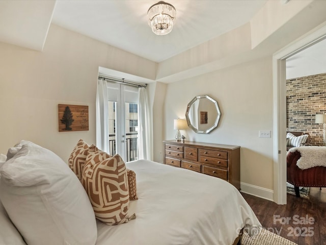 bedroom featuring baseboards, a notable chandelier, dark wood-type flooring, and access to exterior