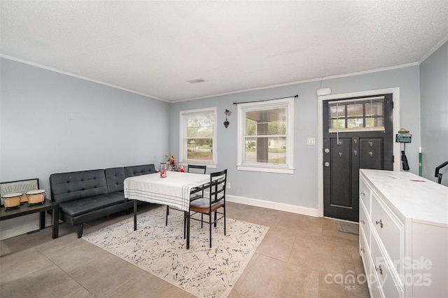 dining room with crown molding, light tile patterned floors, and a healthy amount of sunlight