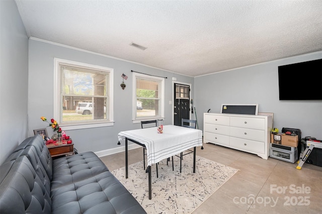 recreation room featuring crown molding, a textured ceiling, visible vents, and light tile patterned floors