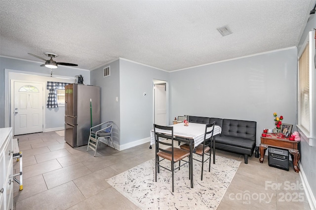 dining room featuring visible vents, ceiling fan, crown molding, and baseboards
