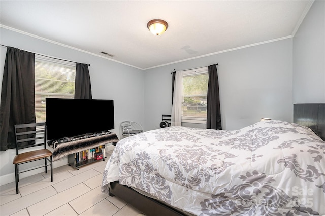 bedroom with light tile patterned floors, visible vents, and ornamental molding