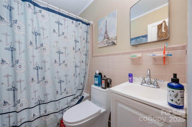 full bathroom with a shower with curtain, tile walls, vanity, crown molding, and toilet