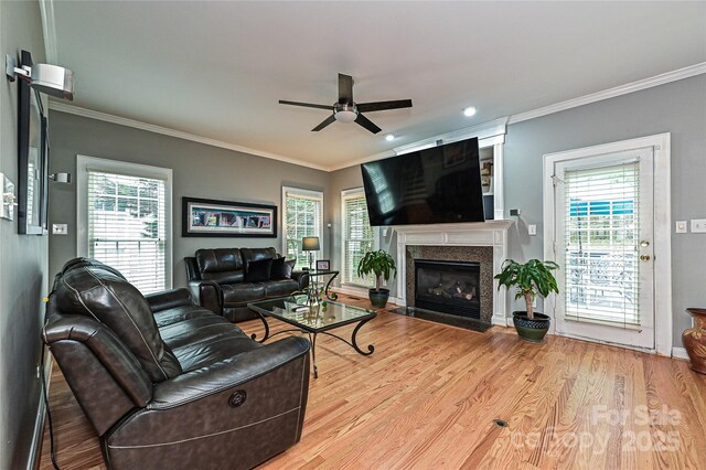 11232 Tradition View Dr, Charlotte, NC 28269 - living area featuring ceiling fan, wood finished floors, a fireplace with flush hearth, ornamental molding, and healthy amount of natural light