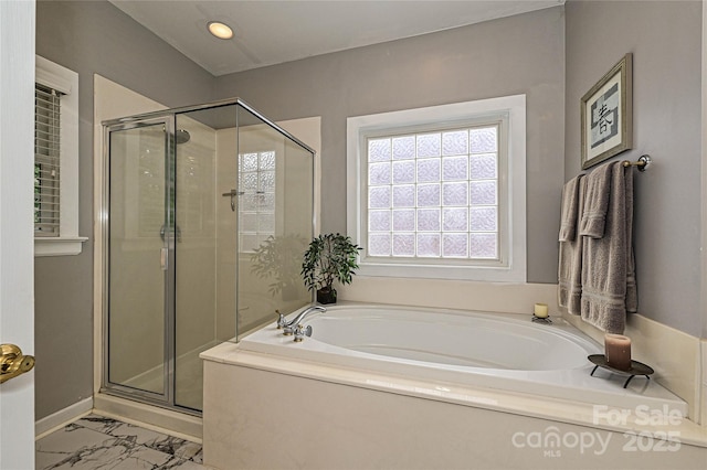 11232 Tradition View Dr, Charlotte, NC 28269 - bathroom featuring a bath, a stall shower, plenty of natural light, marble look tiles, and recessed lighting
