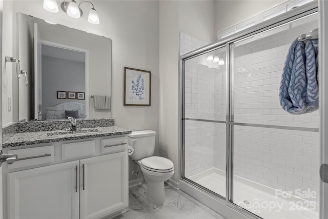 ensuite bathroom with marble finish floor, ensuite bath, toilet, and a shower stall